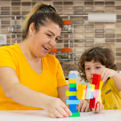 teacher building blocks with student